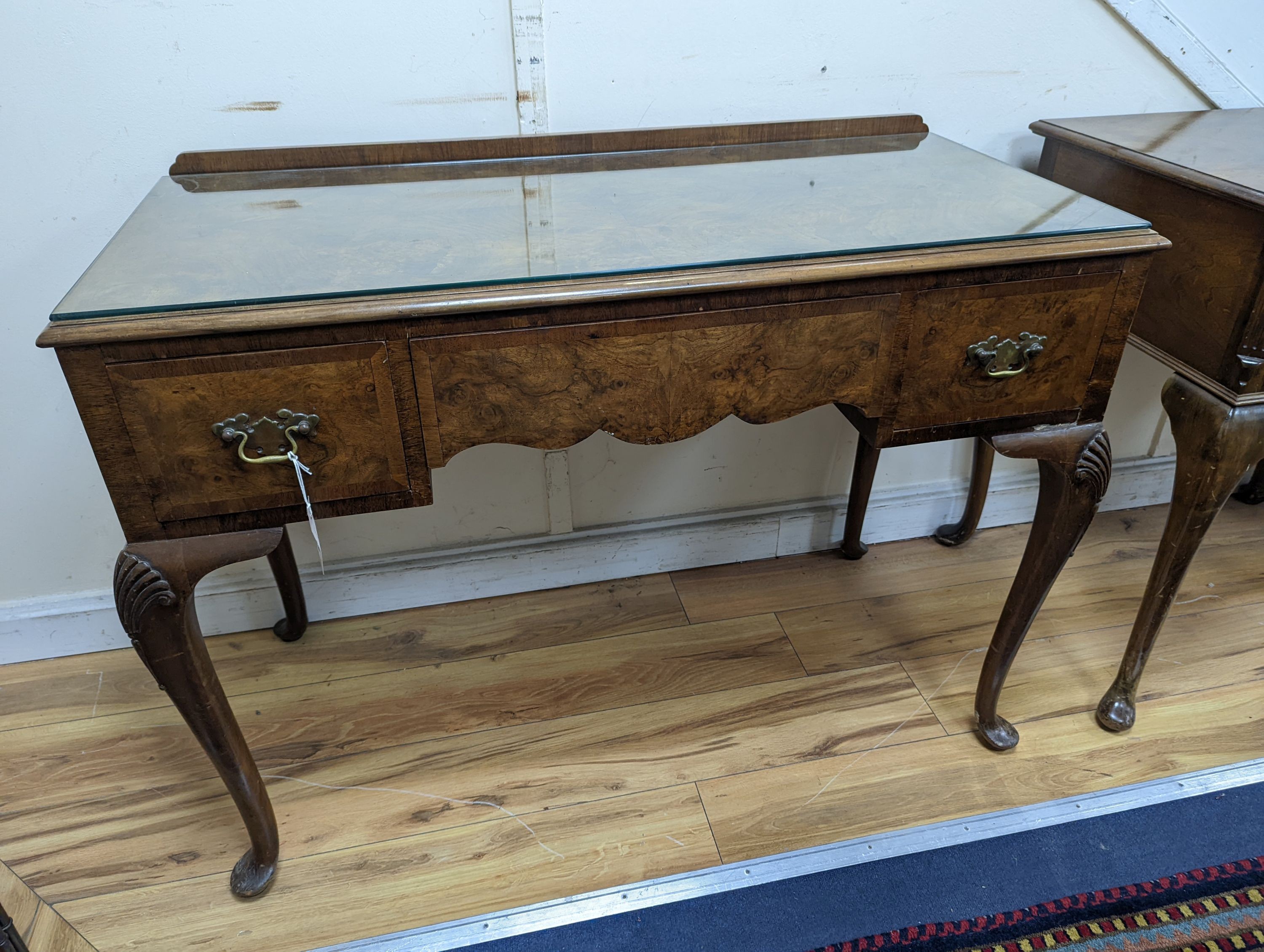 A 1920's Queen Anne revival walnut kneehole dressing table, length 106cm, depth 50cm, height 77cm